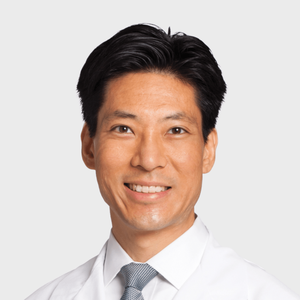 Smiling medical professional in a lab coat, showcasing expertise and approachability.