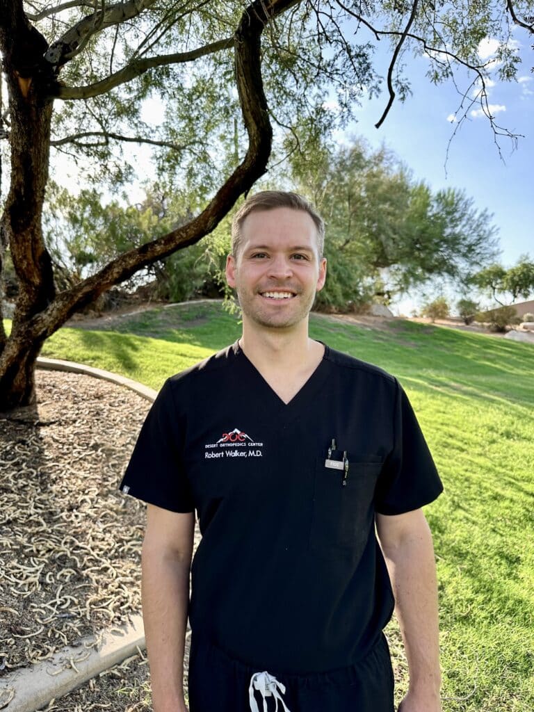 Dr. Robert Walker in scrubs enjoying nature at Desert Orthopedics Center.