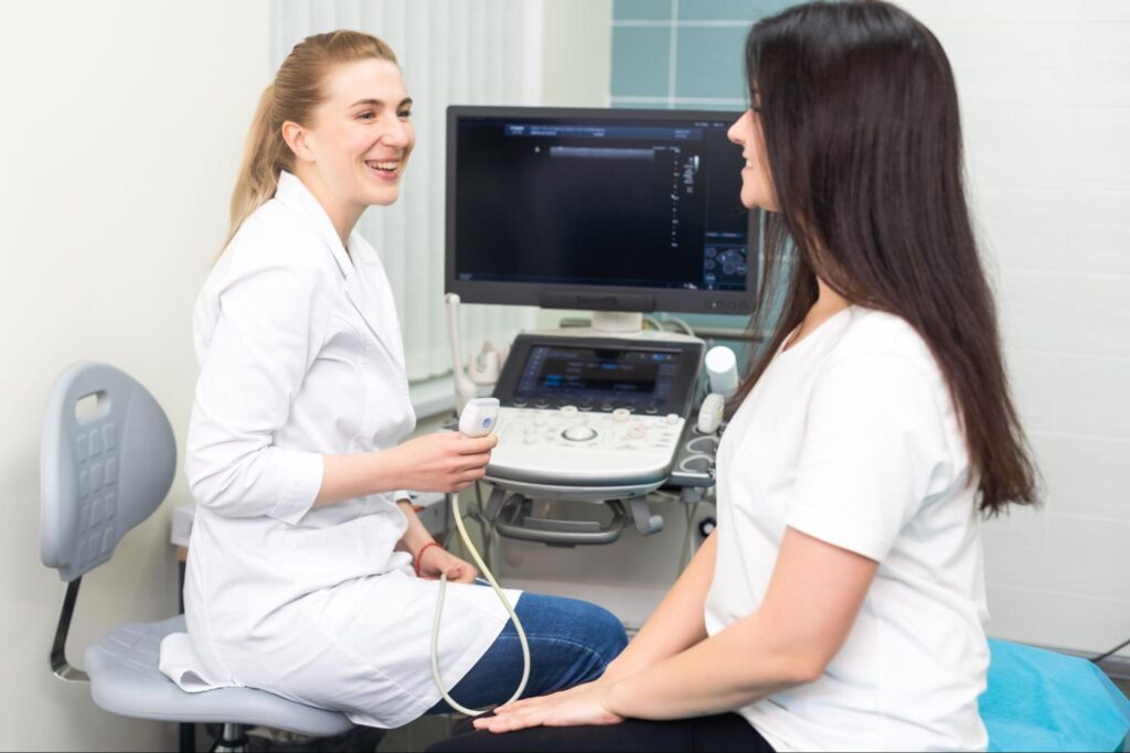 Healthcare professional supports patient during friendly carpal tunnel syndrome ultrasound procedure in modern medical setting.