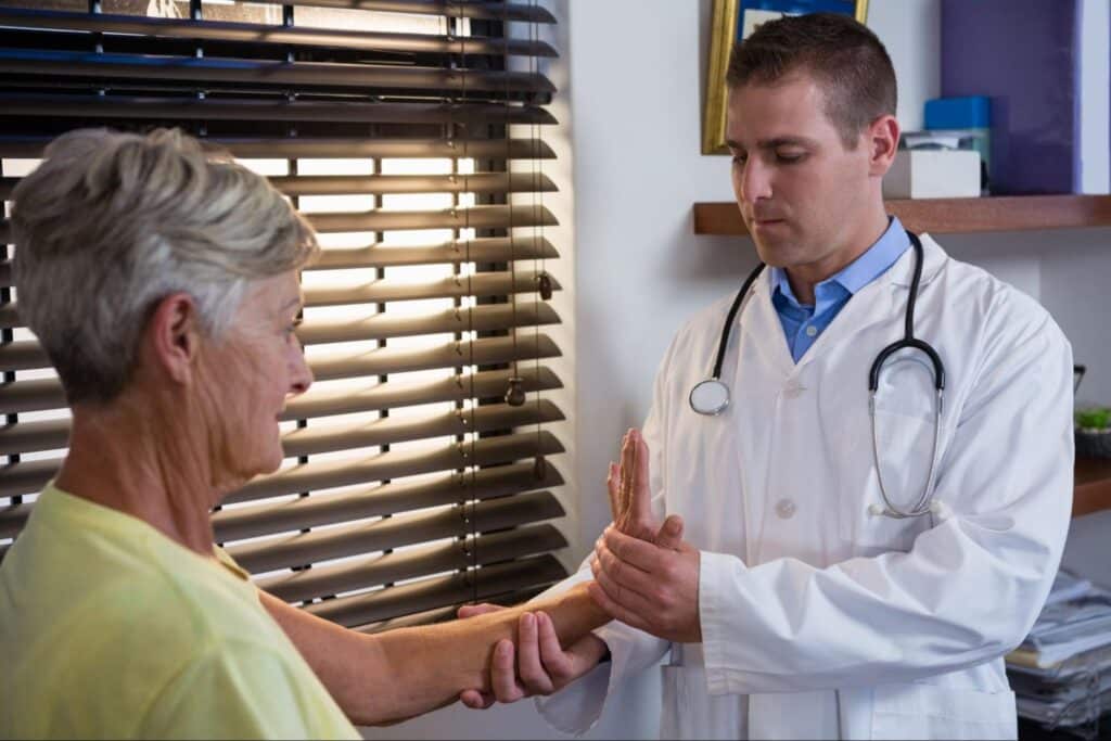 Doctor attentively examines female patient in a bright, caring healthcare setting.