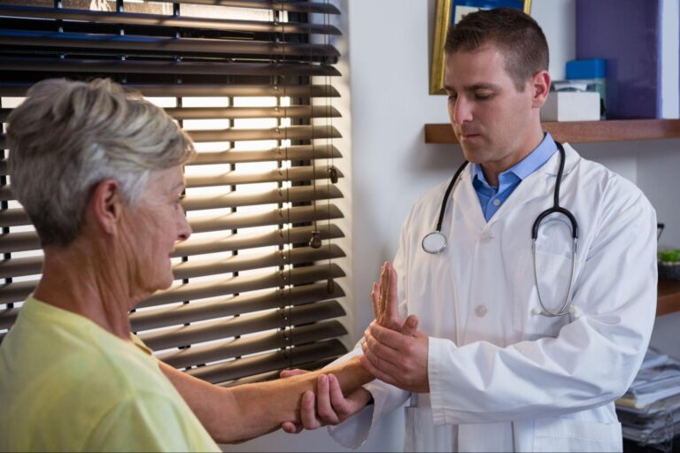 Doctor attentively examines female patient in a bright, caring healthcare setting.